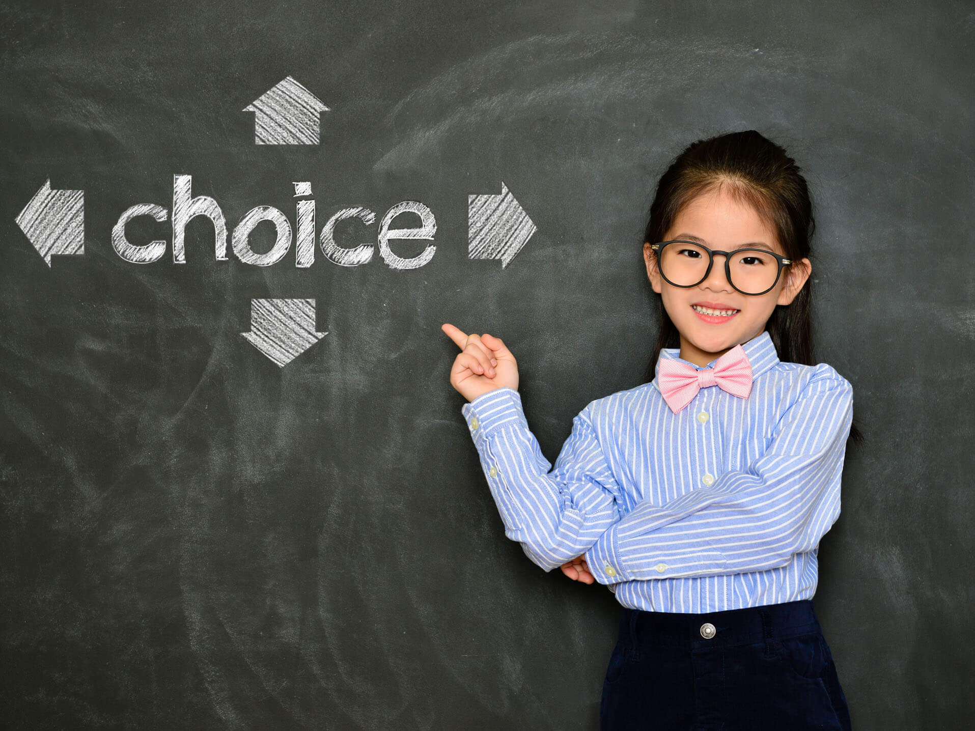 Little girl teaching in front of a board