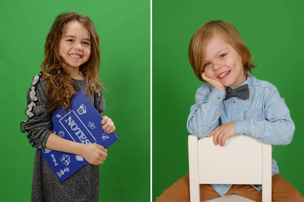 Girl posing with a note book and a boy seating on a chair