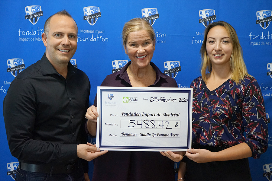 Giving check to Montreal Impact Foundation