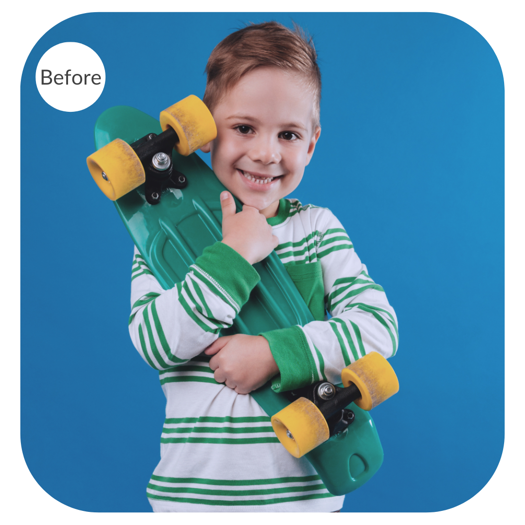 Portrait of a boy holding a skateboard before the image is color corrected
