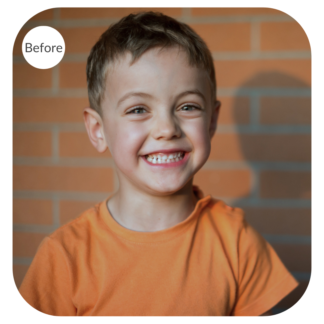 Portrait of a boy against a brick background before the image is color corrected